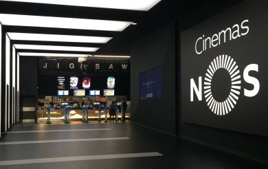 A corridor with the NOS Cinemas logo on the wall